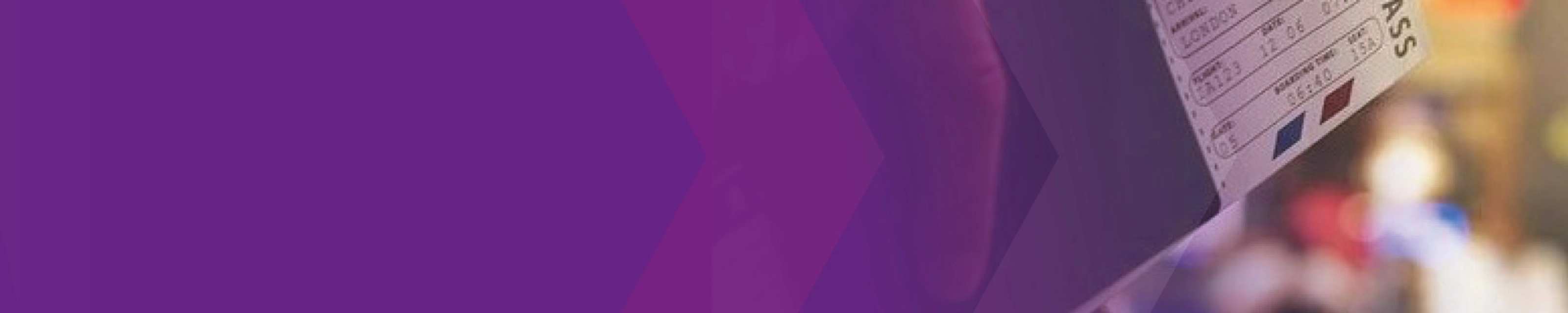 Close-up of a ticket being held at a counter, partly covered by a purple overlay.