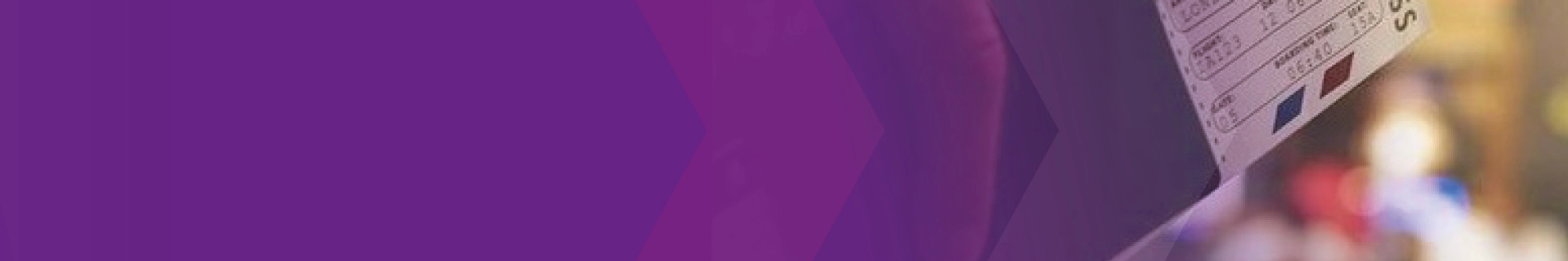Close-up of a ticket being held at a counter, partly covered by a purple overlay.