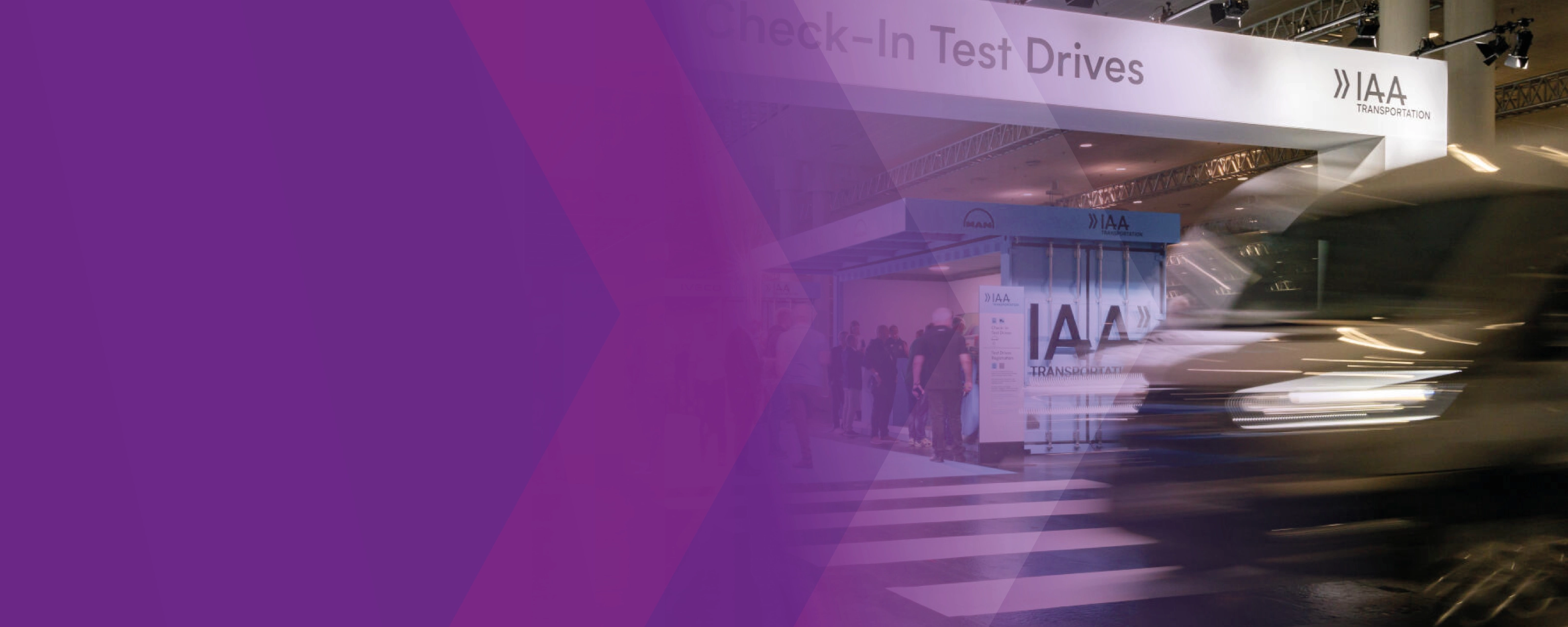 A blurred vehicle passes the IAA Transportation test drive check-in area, partly overlaid with purple graphics.