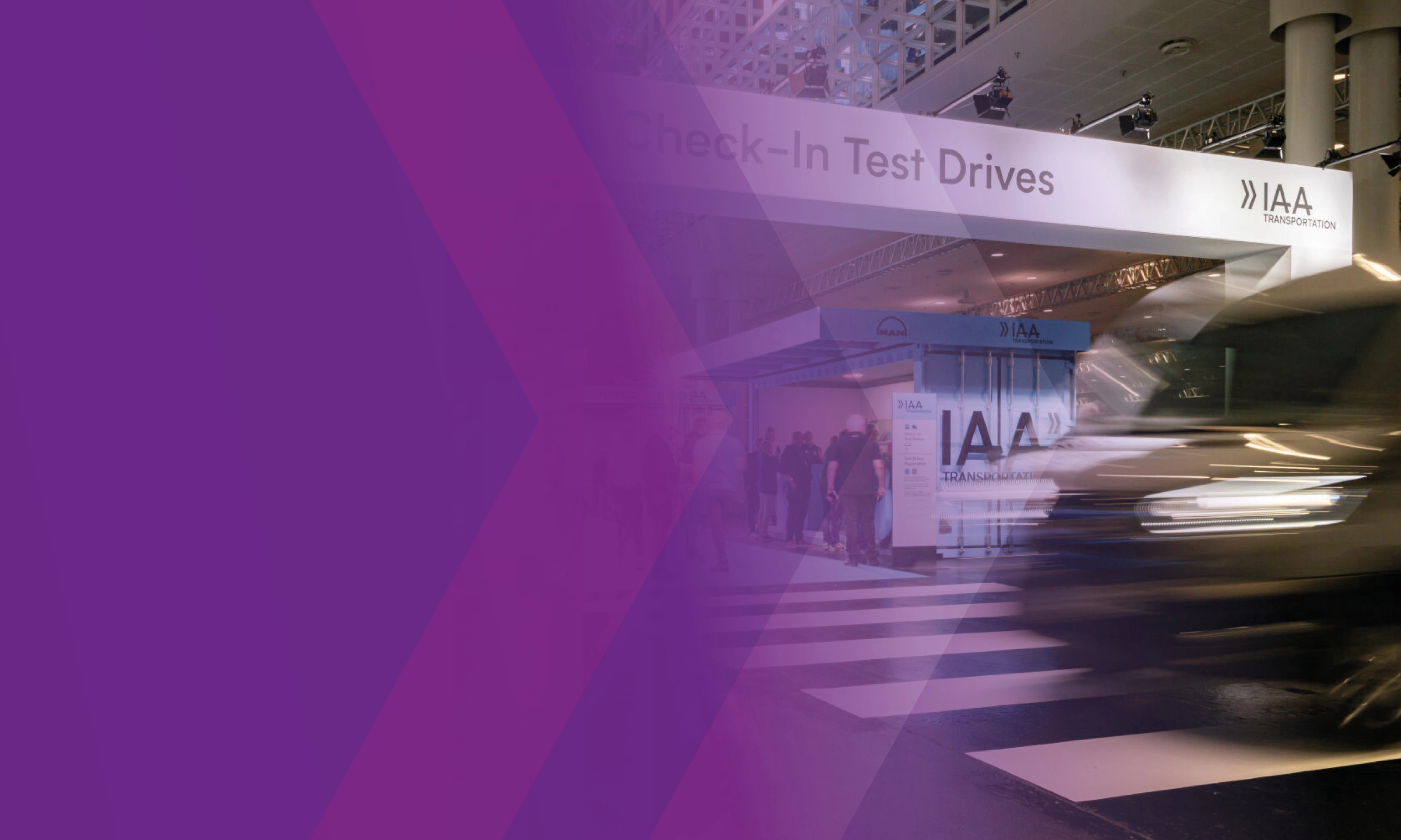 A blurred vehicle passes the IAA Transportation test drive check-in area, partly overlaid with purple graphics.